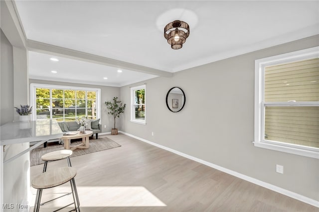 interior space with crown molding, recessed lighting, wood finished floors, and baseboards