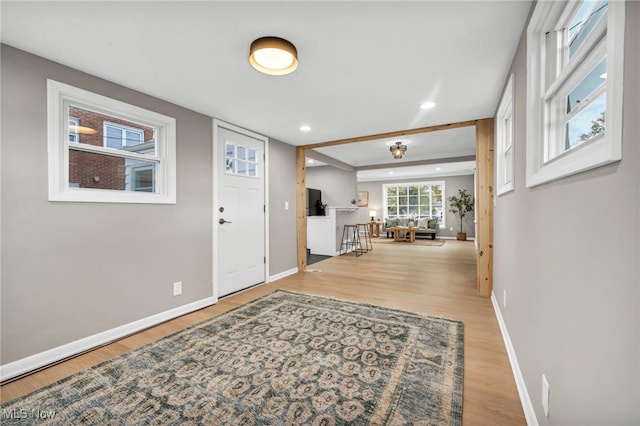 entrance foyer with recessed lighting, baseboards, and light wood finished floors