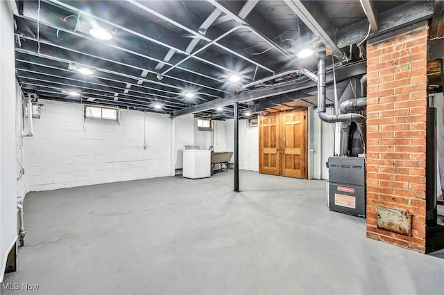 basement featuring washer / dryer and a sink