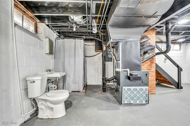 interior space featuring heating unit and a sink