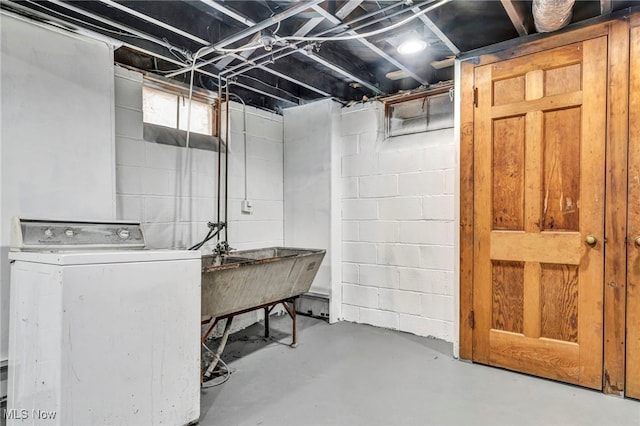 below grade area featuring washer / clothes dryer and a sink