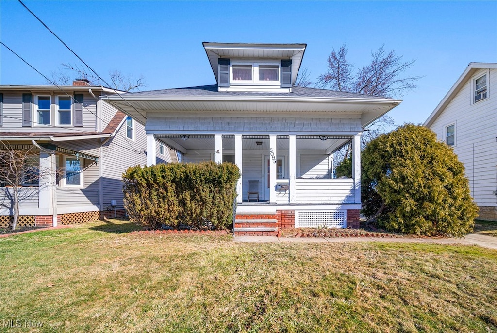 bungalow-style home with a porch and a front yard