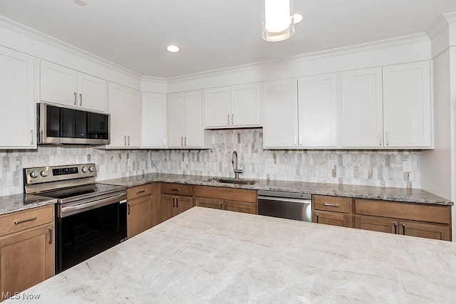 27500 Cedar Rd Unit 804, Beachwood, OH 44122 - kitchen with appliances with stainless steel finishes, a sink, decorative backsplash, light stone countertops, and crown molding