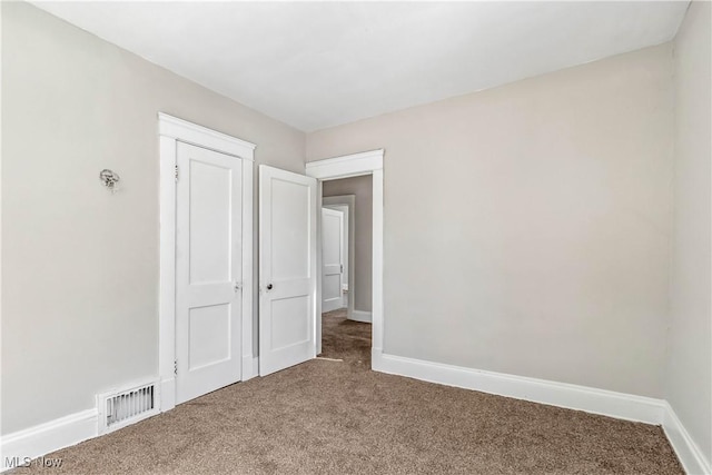 interior space featuring visible vents, baseboards, and carpet floors