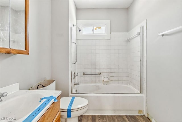 full bathroom with toilet, vanity, shower / bath combination, and wood finished floors