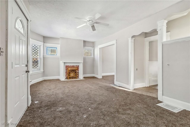 unfurnished living room featuring a ceiling fan, baseboards, carpet, and a fireplace