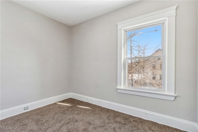 carpeted empty room with baseboards