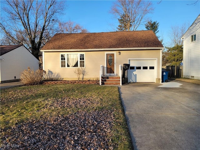 single story home with an attached garage, a shingled roof, and driveway