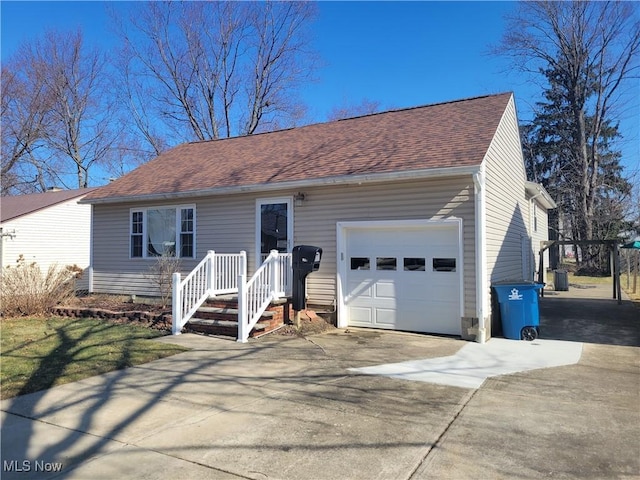 ranch-style home featuring a garage, concrete driveway, and a shingled roof