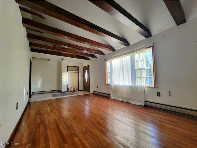 empty room with a baseboard radiator, beamed ceiling, baseboard heating, and hardwood / wood-style flooring