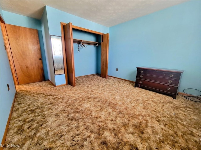 unfurnished bedroom featuring a closet, baseboards, and carpet flooring