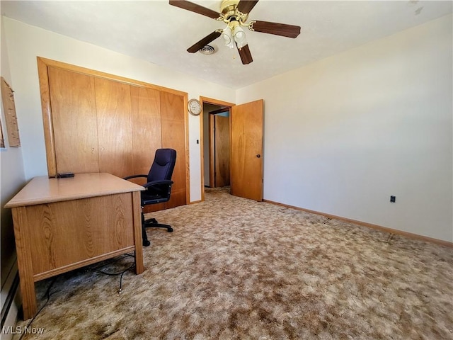 carpeted office space featuring visible vents, a ceiling fan, and baseboards