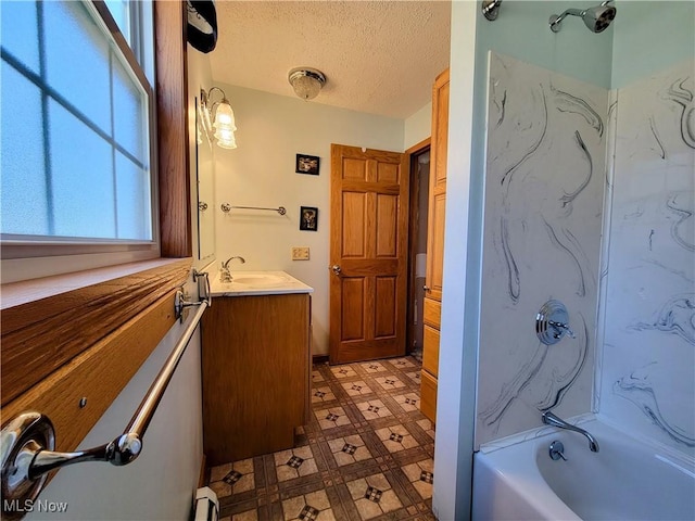 bathroom featuring vanity, a baseboard radiator, a textured ceiling, tile patterned floors, and bathing tub / shower combination