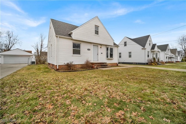 view of front of house with an outbuilding, a garage, and a front yard