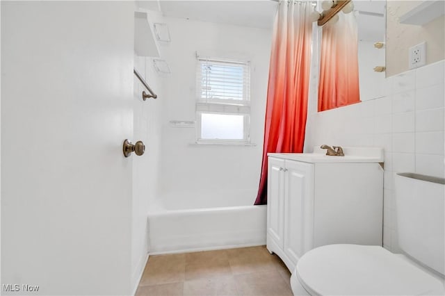 full bath featuring vanity, tile patterned flooring, tile walls, toilet, and shower / tub combo with curtain