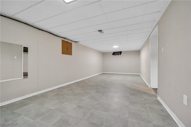 finished basement featuring tile patterned floors and baseboards