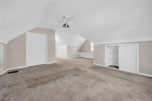 additional living space with lofted ceiling, carpet flooring, baseboards, and ceiling fan