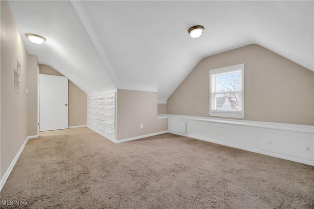 bonus room featuring vaulted ceiling, carpet, and baseboards