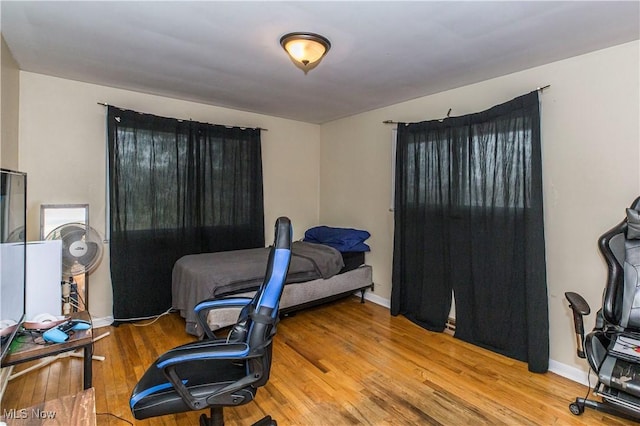 office area with baseboards and wood-type flooring