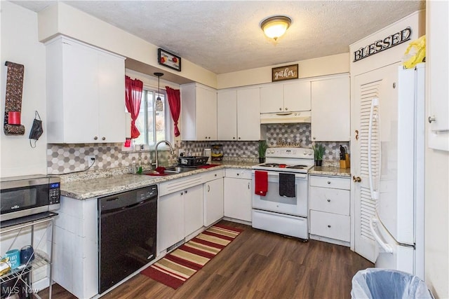 kitchen with dark wood finished floors, white appliances, backsplash, and under cabinet range hood