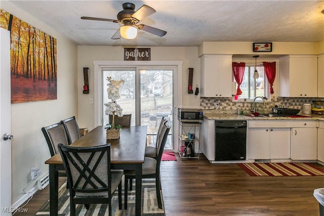 dining space with dark wood-style floors, a textured ceiling, and a ceiling fan