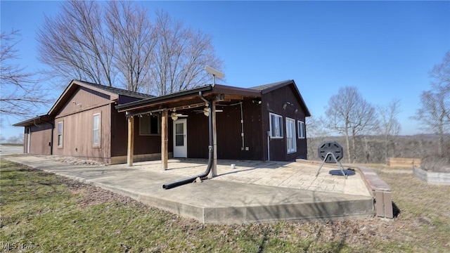 rear view of house with a patio area and a ceiling fan