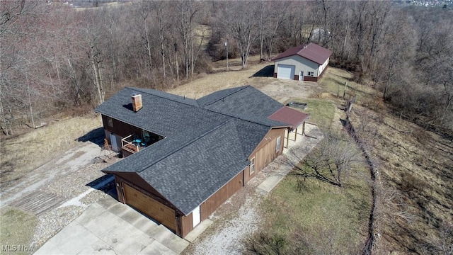 drone / aerial view featuring a forest view