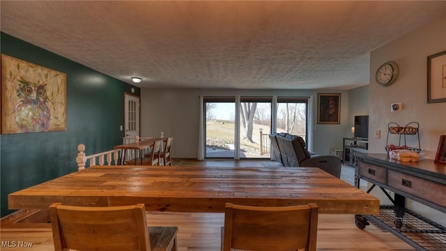 dining space with a textured ceiling