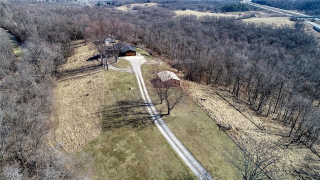 bird's eye view with a wooded view