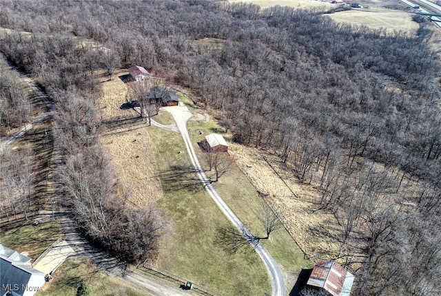 drone / aerial view featuring a forest view