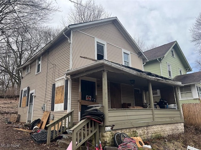 view of front of home with fence, a porch, and entry steps