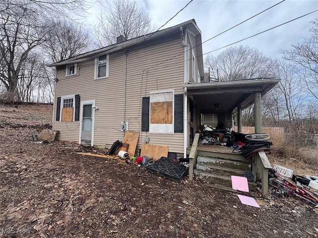 back of property featuring a chimney