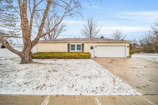 ranch-style home featuring an attached garage and driveway