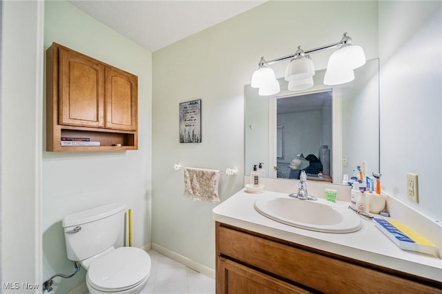 bathroom with vanity, baseboards, tile patterned flooring, ensuite bathroom, and toilet