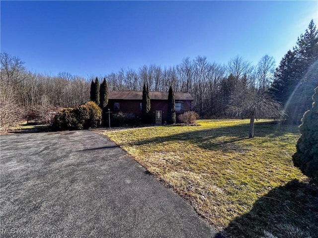 view of property exterior with a yard