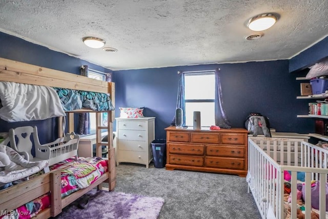carpeted bedroom featuring visible vents and a textured ceiling