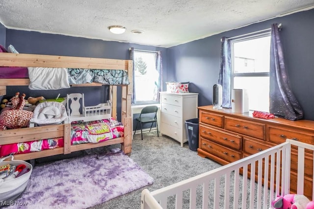 bedroom featuring visible vents, a textured ceiling, and carpet