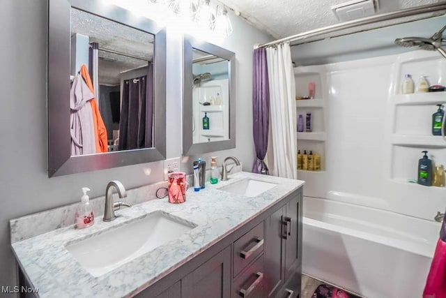full bath featuring visible vents, shower / bath combination with curtain, a textured ceiling, and a sink