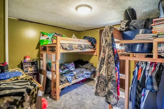 bedroom with a textured ceiling and carpet flooring