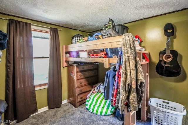 carpeted bedroom featuring multiple windows, baseboards, and a textured ceiling