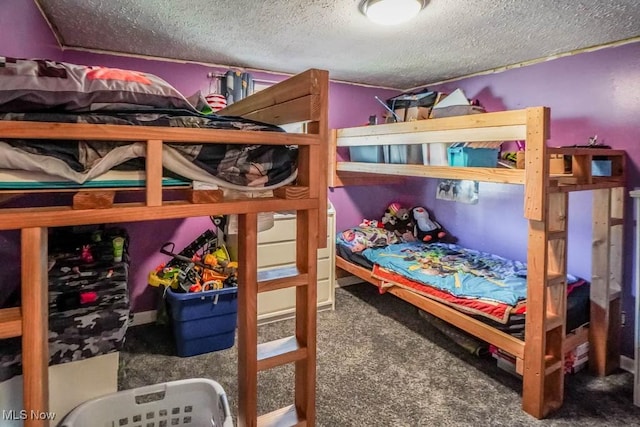 bedroom with carpet floors and a textured ceiling