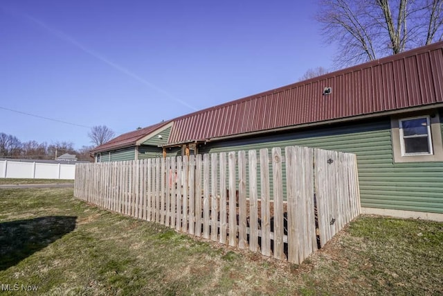 view of side of home featuring fence