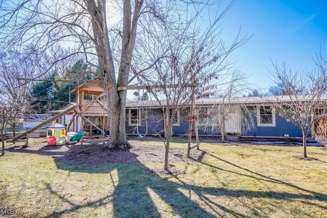 rear view of house with a yard
