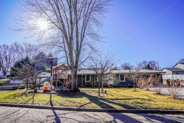 view of front facade featuring a front yard and a playground
