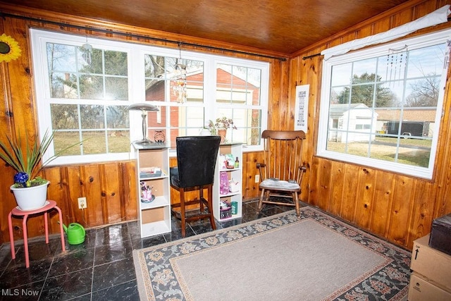 home office featuring a wealth of natural light, wood walls, granite finish floor, and wood ceiling