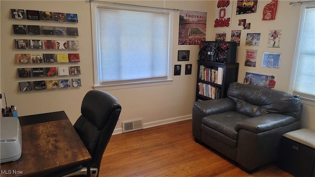 home office with visible vents, baseboards, and wood finished floors