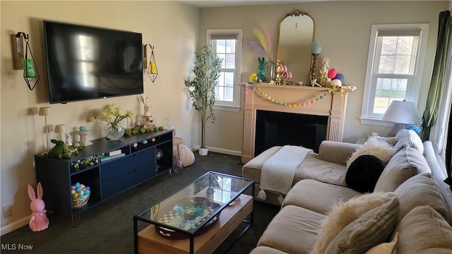 living room featuring a fireplace, carpet, and baseboards