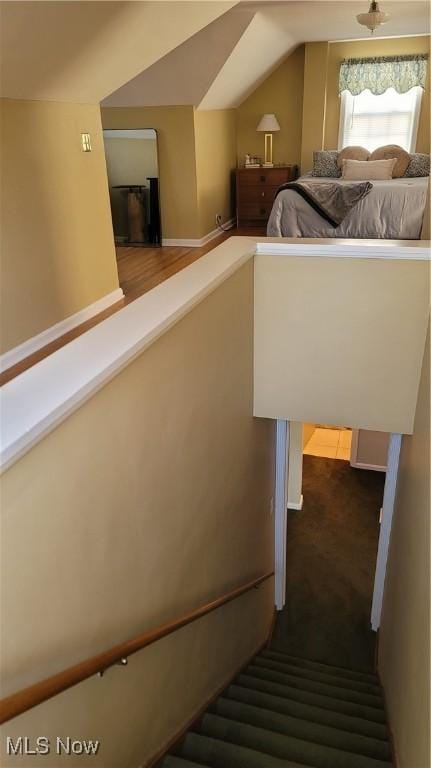 stairway featuring lofted ceiling