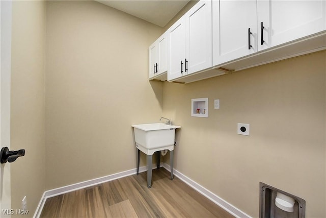 laundry area featuring cabinet space, hookup for an electric dryer, hookup for a washing machine, and baseboards