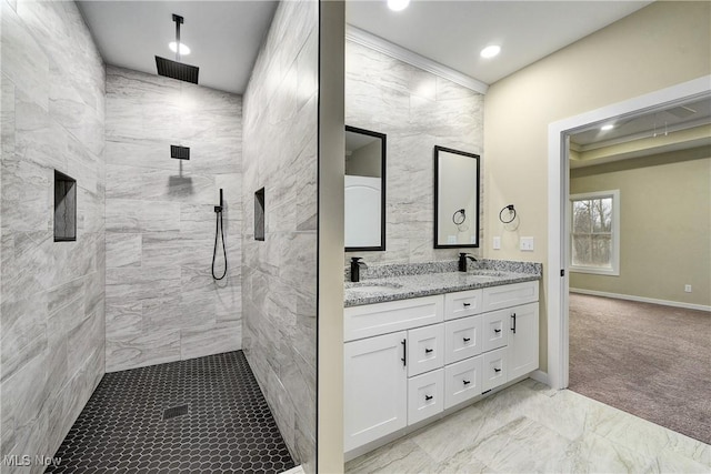 full bathroom featuring double vanity, recessed lighting, tiled shower, and a sink